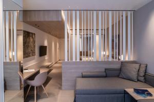 a living room with a couch and a table at Sicilia's Art Hotel & Spa in Acitrezza