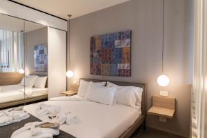a hotel room with a bed and a mirror at Sicilia's Art Hotel & Spa in Acitrezza