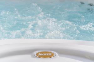 a sign on the edge of a bath tub with water at Sicilia's Art Hotel & Spa in Acitrezza