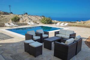 - un groupe de chaises et une piscine dans l'établissement Lagada Resort, à Makry Gialos