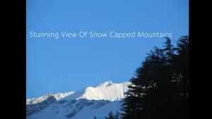 a view of snow capped mountains at Manali Top Inn in Manāli