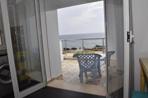 a room with a view of the ocean from a door at Arabesque Style - 2 appartements in Kelibia