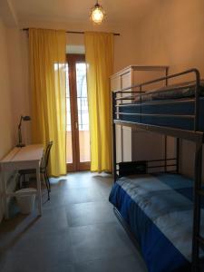 a room with two bunk beds and a table and a desk at La casetta di Anastasia in Rome