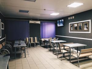 a dining room with tables and chairs and purple walls at Hostel on Komsomolskaya in Sochi