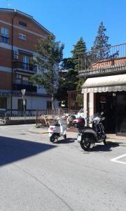 two motor scooters parked on the side of a street at Marconi Rooms 1, 2, 3 Casa Stella in Verona