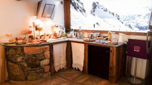 a kitchen with a counter with food on it at Maison Le Cler in Valtournenche