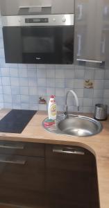 a kitchen counter with a sink and a detergent bottle at Hostel Tip Top in Gdańsk