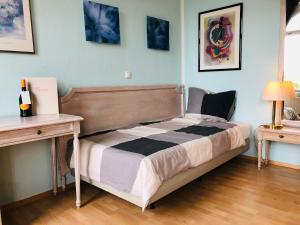 a bedroom with a bed and a desk with a lamp at Apartments in der Friedrich Ebert Straße 90 Sportforum in Leipzig