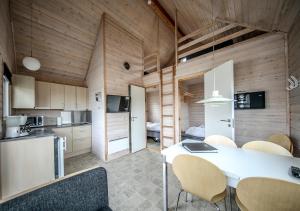 a kitchen and dining room with a table and chairs at Thyborøn Cottages in Thyborøn