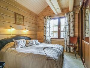 a bedroom with a bed in a wooden cabin at Holiday Home Ruuhikari by Interhome in Ulvila