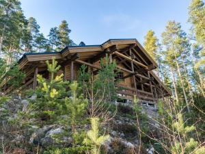 a log cabin in the woods at Holiday Home Roopenranta by Interhome in Asikkala