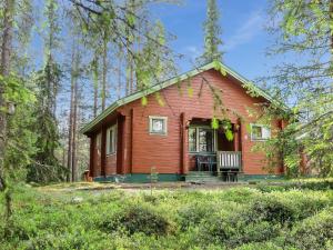 a small house in the middle of a forest at Holiday Home Lomamaja 3 by Interhome in Raattama