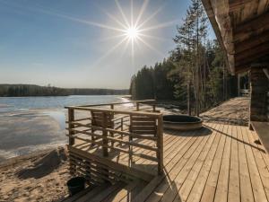 a wooden dock with a boat on a lake at Holiday Home Villa moose by Interhome in Jukara