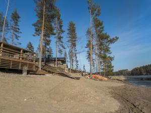a building on the shore of a beach with trees at Holiday Home Villa moose by Interhome in Jukara