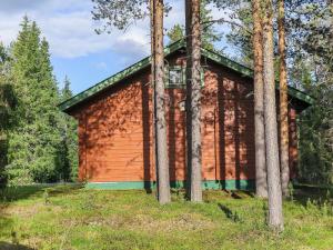 a red building in the middle of some trees at Holiday Home Lomamaja 3 by Interhome in Raattama +11 photos