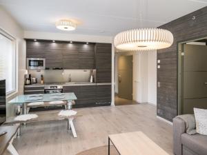 a living room with a table and a kitchen at Holiday Home Tunturinlaita d 4 by Interhome in Levi