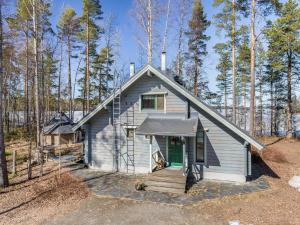 a small house in the middle of a forest at Holiday Home Villa populus by Interhome in Pertunmaa