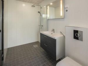 a bathroom with a sink and a shower and a toilet at Holiday Home Kasnäs marina b 16 by Interhome in Kasnäs +9 photos