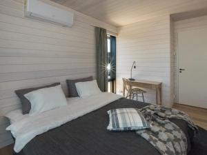 a bedroom with a large bed and a table at Holiday Home Kasnäs marina b 16 by Interhome in Kasnäs