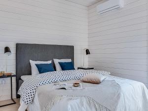 a bedroom with a large bed with blue pillows at Holiday Home Kasnäs marina c 22 by Interhome in Kasnäs