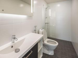a white bathroom with a toilet and a sink at Holiday Home Kasnäs marina b 16 by Interhome in Kasnäs