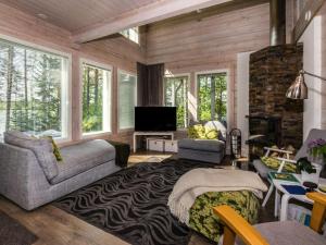 a living room with a couch and a tv at Holiday Home Villa ina by Interhome in Evijärvi