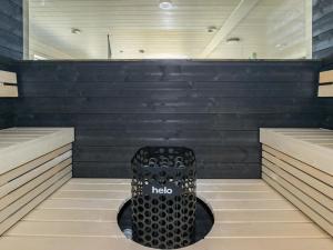 a sauna with a black wall and a black stool at Holiday Home Kasnäs marina b 16 by Interhome in Kasnäs