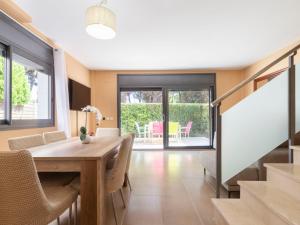a dining room with a wooden table and chairs at Holiday Home Sol Cambrils Park-6 by Interhome in Cambrils