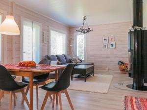 a living room with a table and a couch at Holiday Home Tapiska by Interhome in Taivalkoski