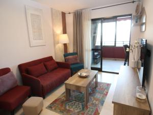 - un salon avec un canapé rouge et une table basse dans l'établissement Apartment Trinisol II Playa by Interhome, à Benidorm