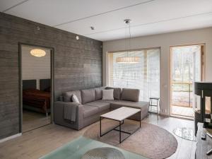 a living room with a couch and a table at Holiday Home Tunturinlaita d 4 by Interhome in Levi