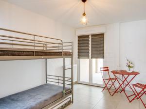 a bedroom with bunk beds and a table at Apartment Palazzo Ribotti by Interhome in Nice