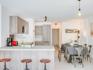 a kitchen and dining room with a table and chairs at Apartment Palazzo Ribotti by Interhome in Nice