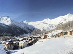 a town in the snow with mountains in the background at Apartment Bijou by Interhome in Saas-Fee