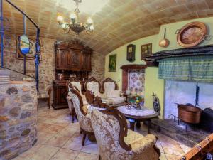 a room with chairs and a table and a fireplace at Holiday Home Can Funei by Interhome in Calonge