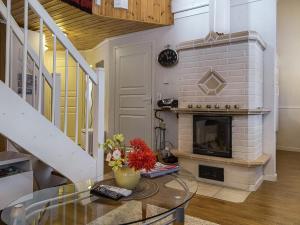 a living room with a fireplace and a glass table at Holiday Home Lepolinna b by Interhome in Tahkovuori