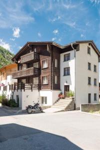 a building with a motorcycle parked in front of it at Apartment Zur Post by Interhome in Saas-Almagell