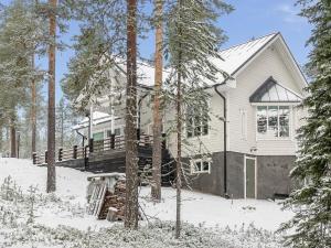 a house in the woods in the snow at Holiday Home Teppolan rinne by Interhome in Salla