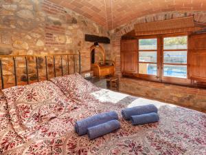 a bedroom with a large bed with pillows on it at Holiday Home Can Funei by Interhome in Calonge