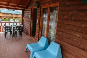 a patio with blue chairs and a table on a deck at Apartments Mizo in Ohrid +2 photos