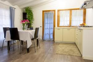 a kitchen and dining room with a table and chairs at Antiche Mura in Riva del Garda