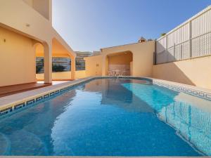 a swimming pool in front of a house at Villa Flor de Maio by Interhome in Patroves