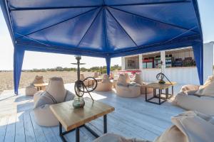 a large blue tent with couches and tables at Hotel Promenad in Zatoka