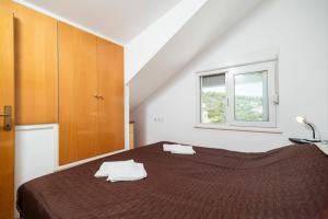 a bedroom with a bed and a window at Apartments Fran in Vela Luka +33 photos