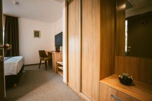 a hotel room with a bedroom with a bed and a desk at Pansion Bernarda Nova in Varaždinske Toplice +34 photos