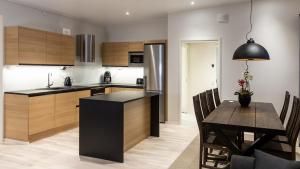 a kitchen with a table and a dining room at Luxury suites Pannunkorva C in Rovaniemi
