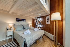 a bedroom with a bed and a ladder in it at Le Santel 199 in Val dʼIsère