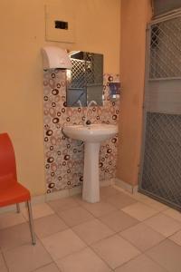 a bathroom with a sink and a mirror at Viriko Boarding House in Mombasa