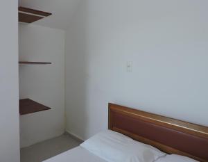 a bed in a room with a large window at Consulado Praia Hotel in Guarujá