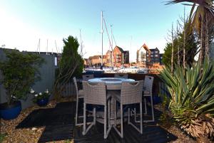 a table and chairs on a patio with a marina at Marina Views in Eastbourne